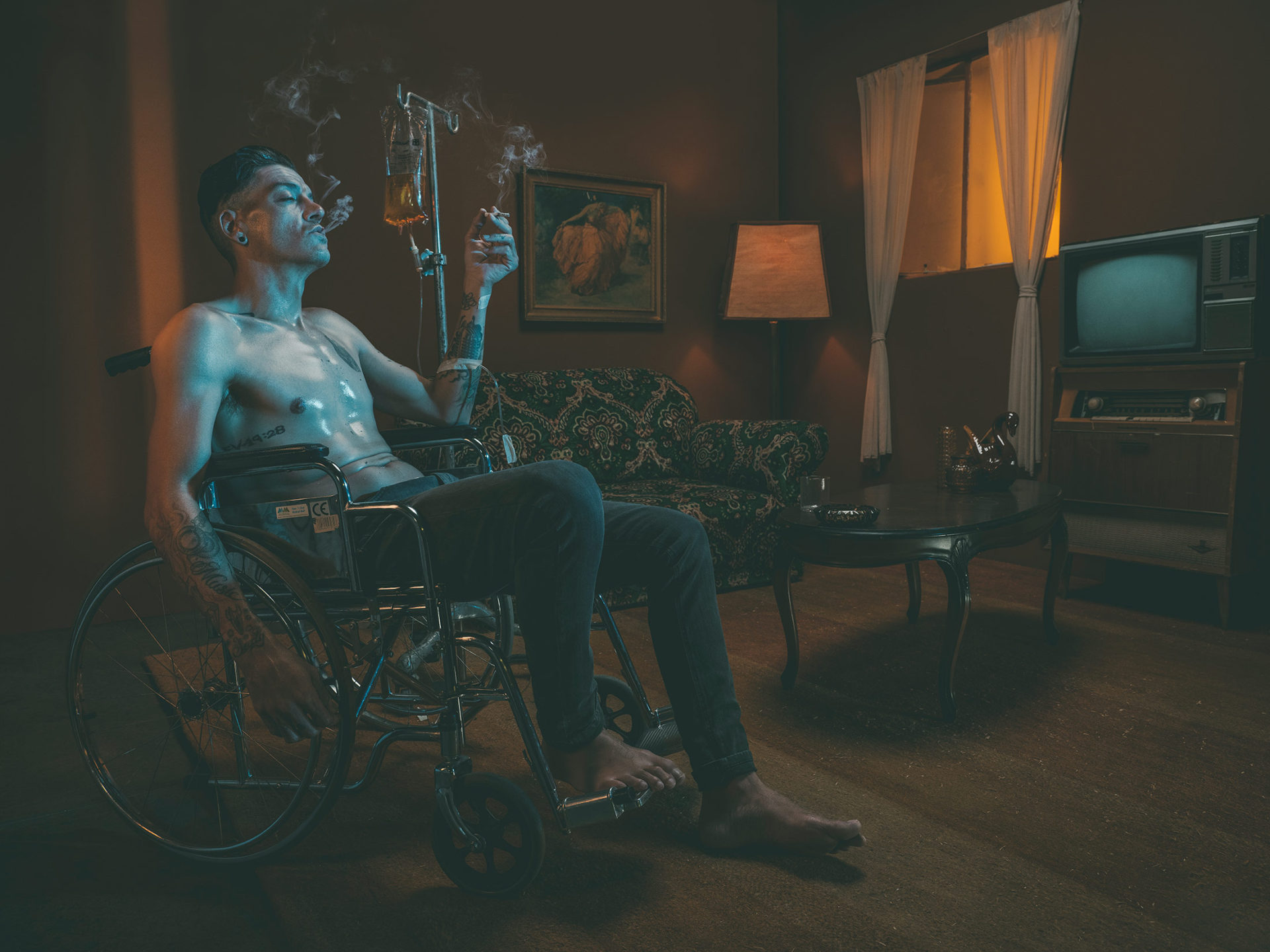 silva black smoking in a wheelchair with iv bags