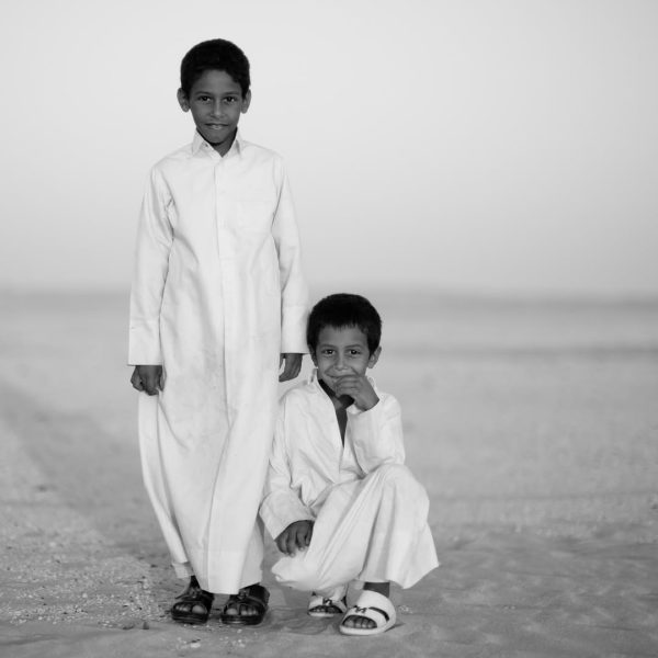 While out in the Qatar desert photographing, a Jeep came by with a family. The two sons were ver